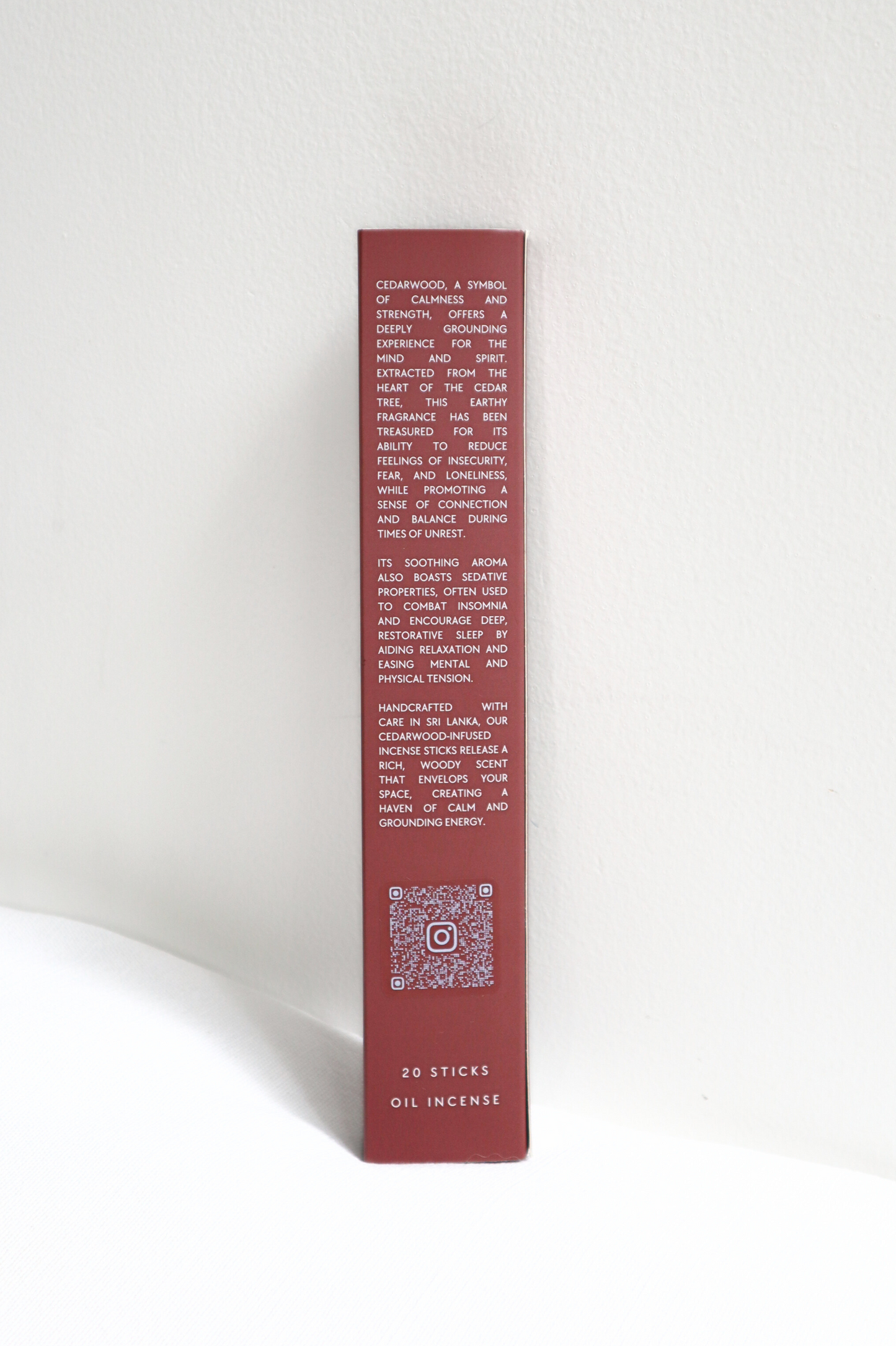 Red cylindrical incense box with text on a white background