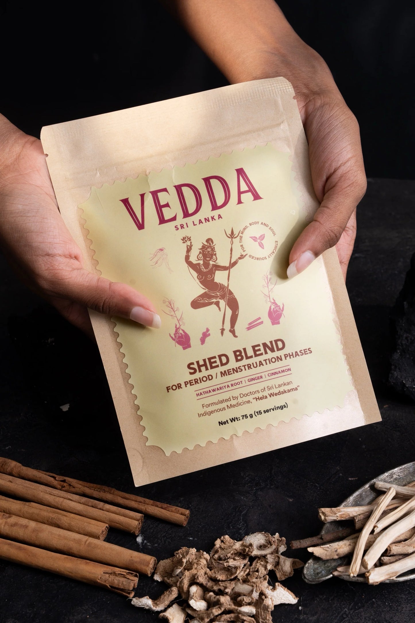 Hand holding a package of Vedda Sri Lanka Shed Blend on a dark background