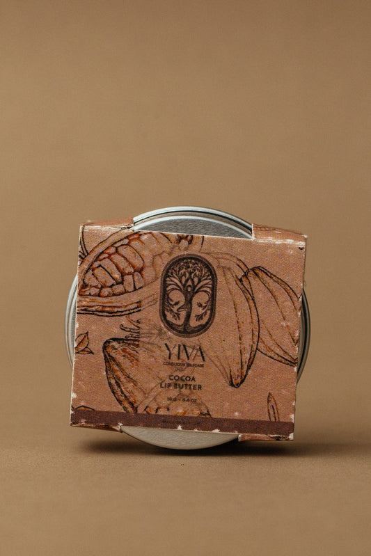 Yiva cocoa lip butter packaging on a brown background