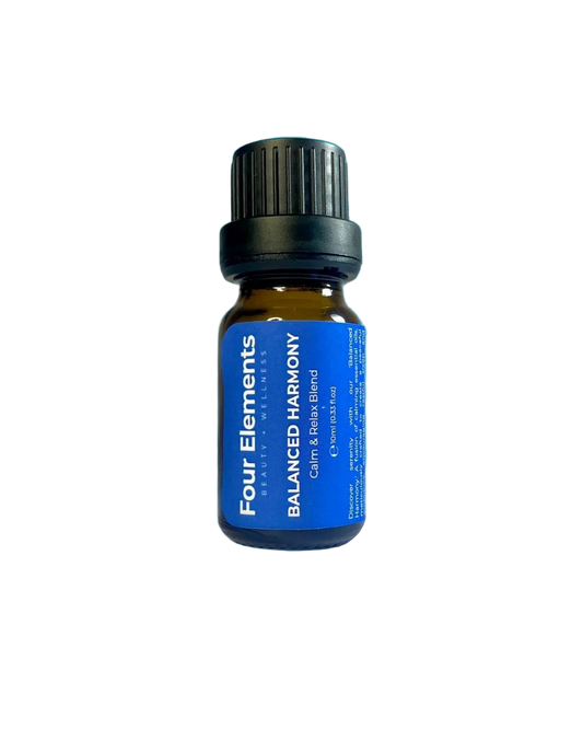 Bottle of Four Elements Balanced Harmony essential oil on a blue background