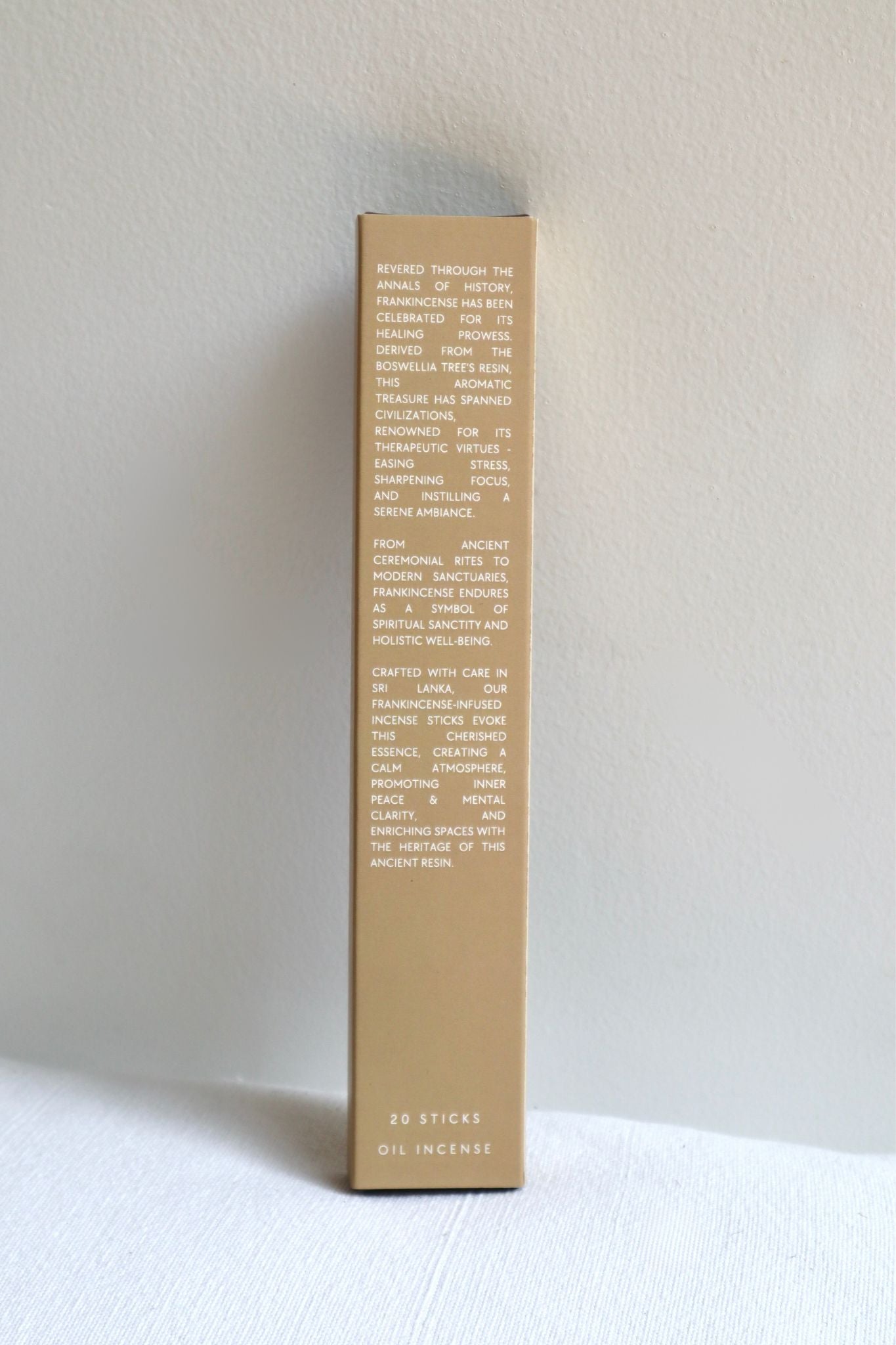 Tall rectangular box with text on a white surface and light gray background