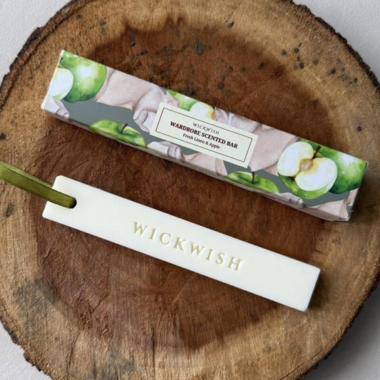 Wickwish scented bar and packaging on a wooden surface
