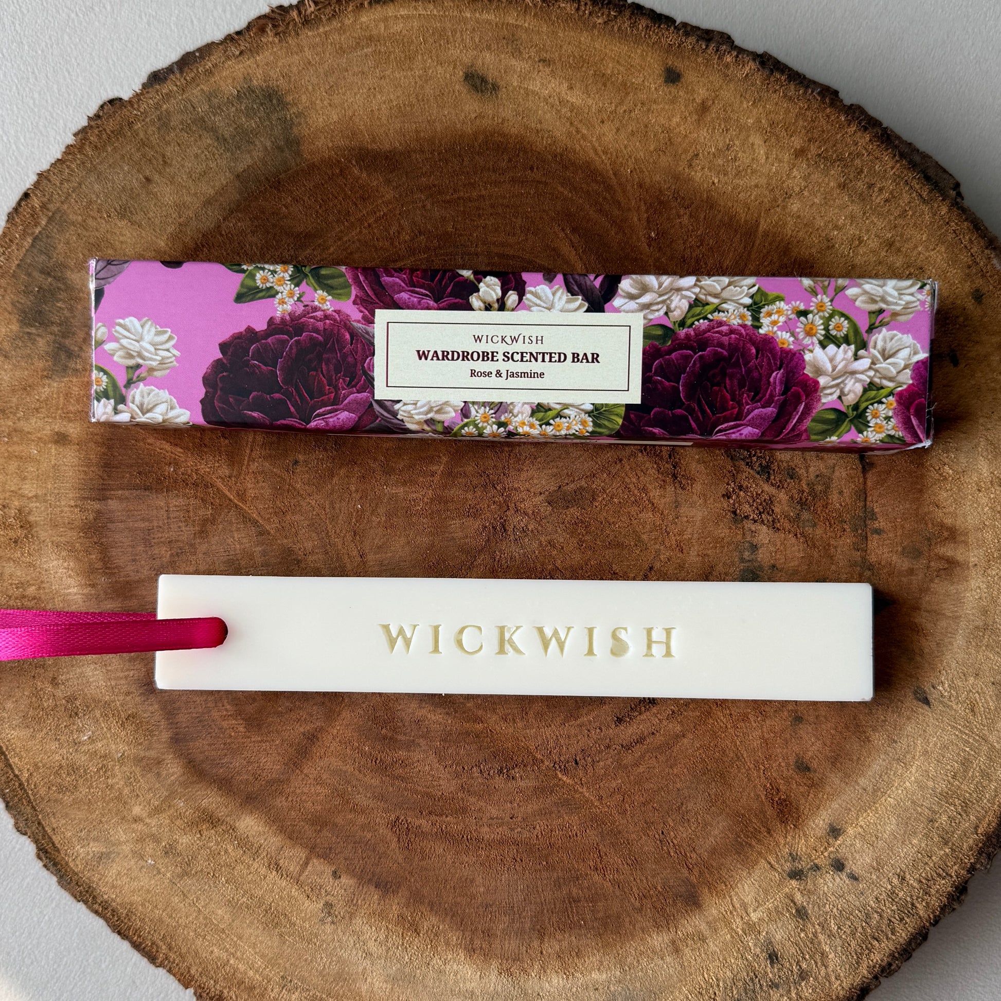Wickwish scented bar on a wooden surface with floral packaging